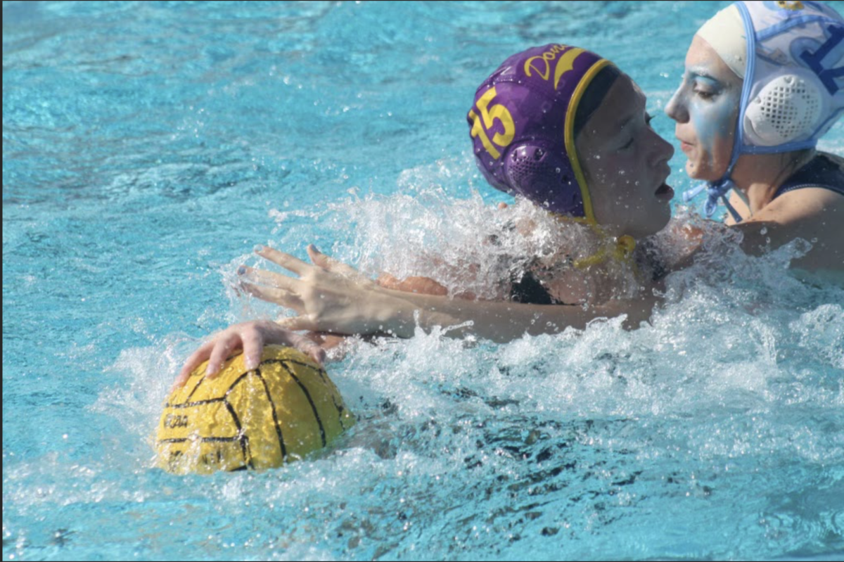 Playing in rough water, Amador Player 15 keeps her focus on while facing the tough defense.